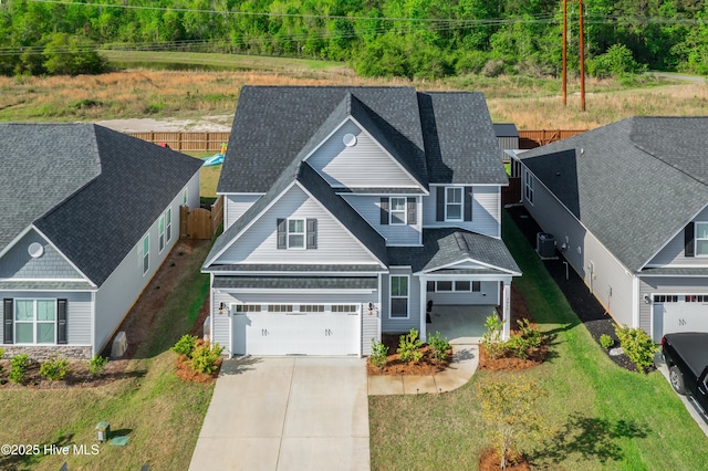 view of front of property featuring a garage and central air condition unit