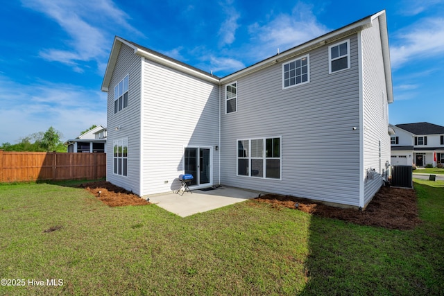 rear view of property with a yard, central AC unit, and a patio area