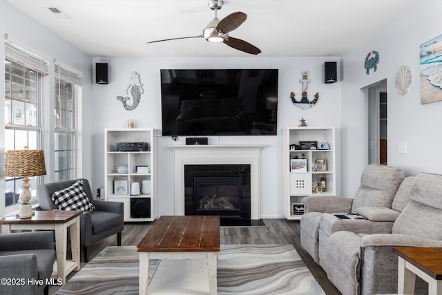 living room featuring dark hardwood / wood-style floors and ceiling fan