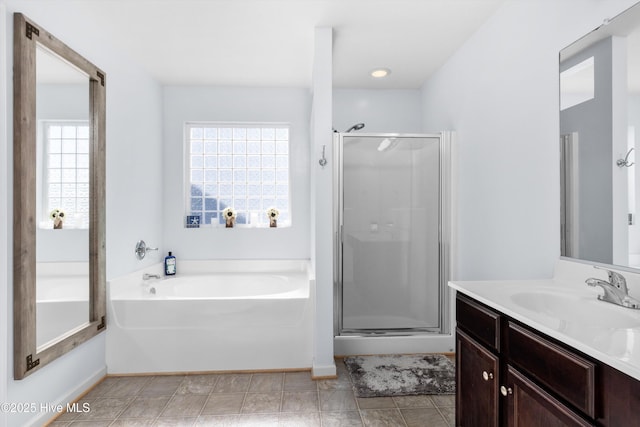 bathroom with vanity and separate shower and tub