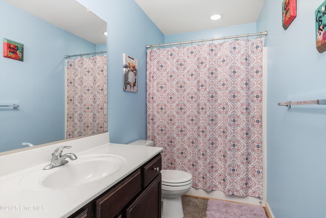 bathroom with vanity, toilet, and tile patterned flooring