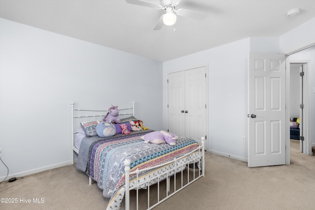 carpeted bedroom featuring ceiling fan and a closet