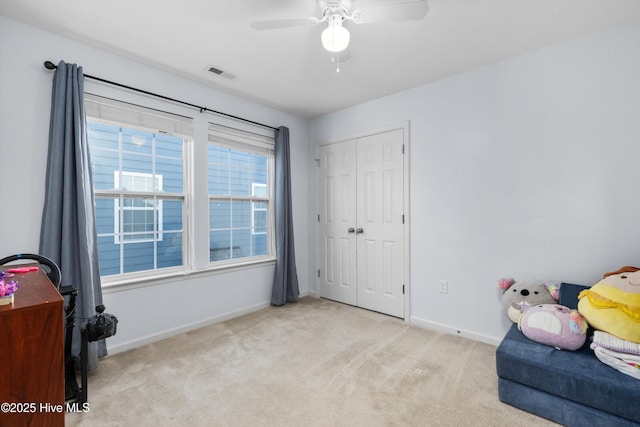 sitting room featuring ceiling fan and light carpet