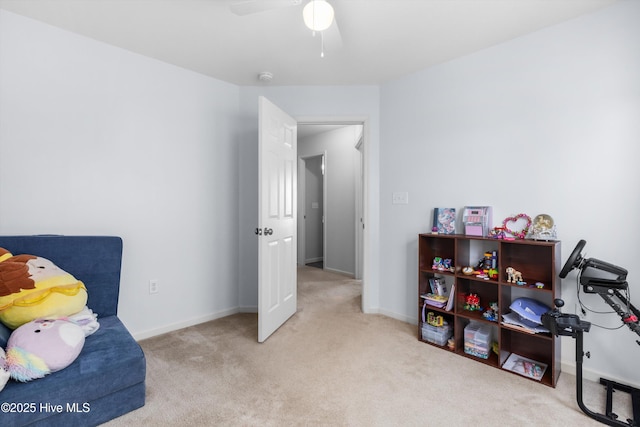 interior space featuring ceiling fan and light colored carpet