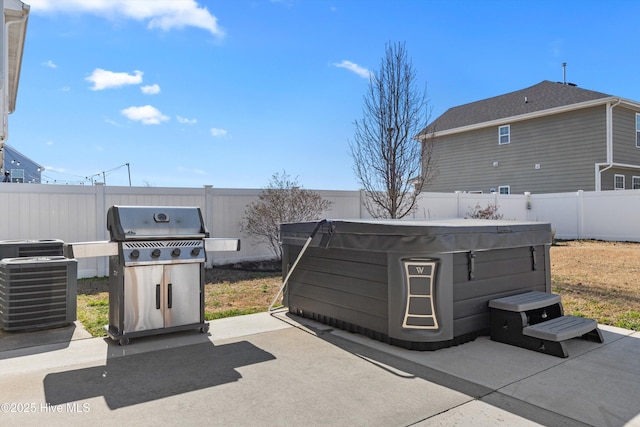 view of patio with cooling unit, a grill, and a hot tub