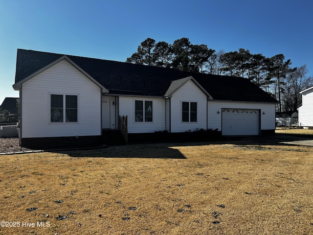 view of front of property featuring a garage and a front lawn