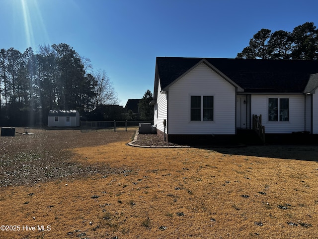 view of property exterior featuring a lawn and a shed