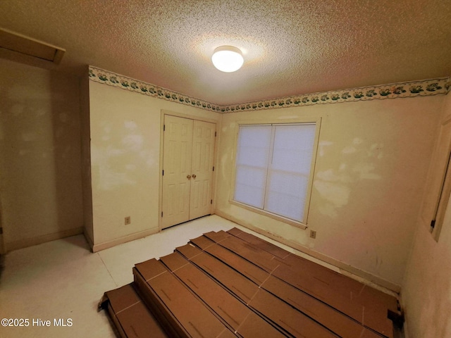 unfurnished bedroom with a closet and a textured ceiling