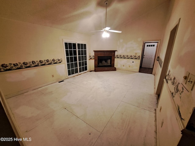 unfurnished living room with ceiling fan and vaulted ceiling