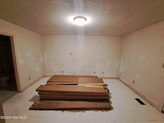 basement featuring a textured ceiling