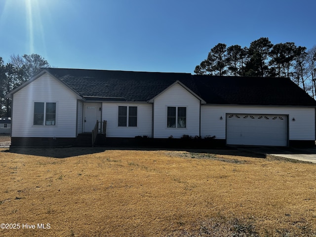 ranch-style house featuring a garage and a front yard