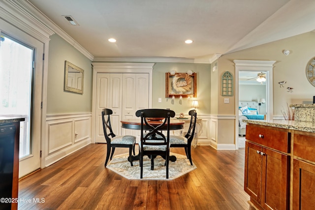 dining room with crown molding, recessed lighting, visible vents, dark wood-type flooring, and wainscoting