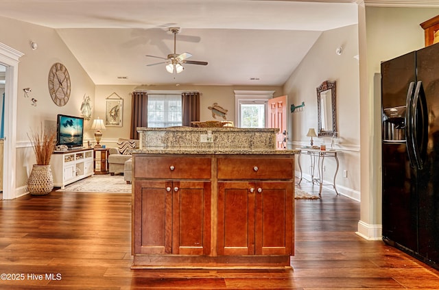 kitchen with dark wood-style floors, black refrigerator with ice dispenser, open floor plan, vaulted ceiling, and light stone countertops