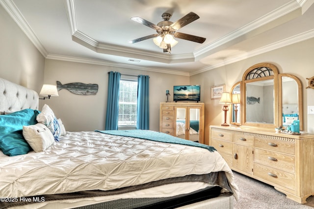 carpeted bedroom featuring a raised ceiling, a ceiling fan, and crown molding