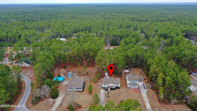 birds eye view of property with a forest view