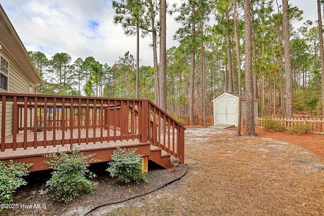 view of yard with an outbuilding, a wooden deck, and a storage shed