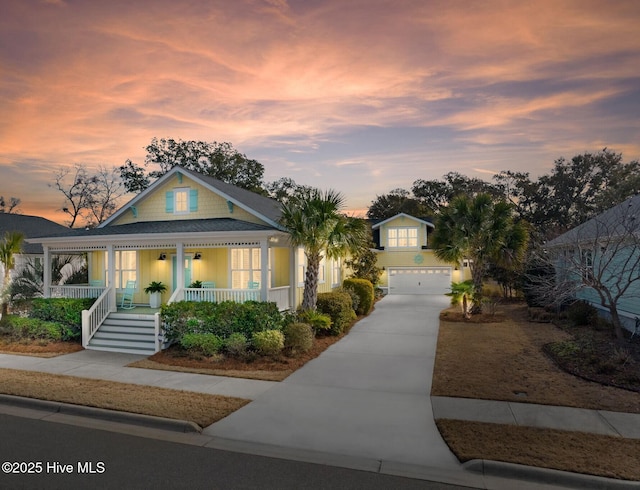 view of front of home with a porch, driveway, and an attached garage