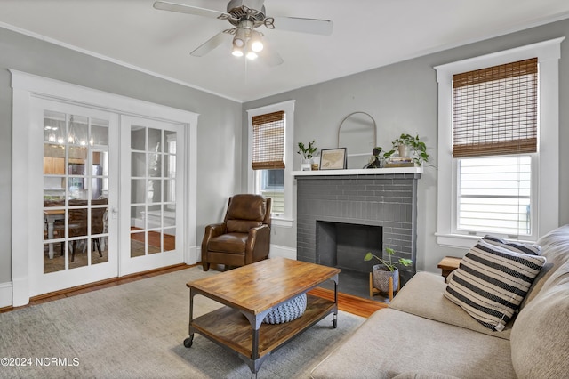 living room with ceiling fan, a fireplace, and hardwood / wood-style floors