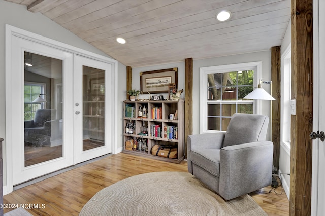 sitting room featuring vaulted ceiling, wooden ceiling, french doors, and light wood-type flooring