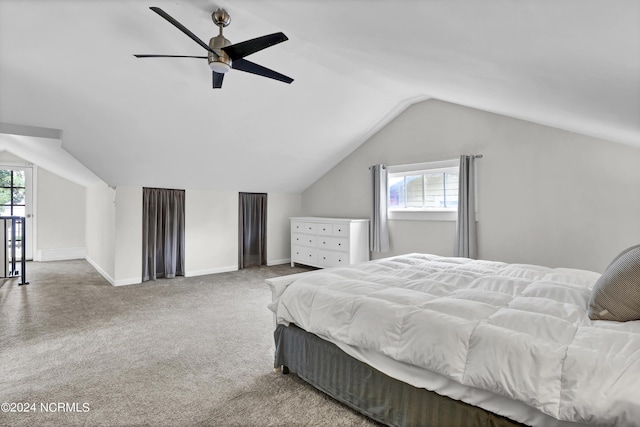 carpeted bedroom featuring ceiling fan, vaulted ceiling, and multiple windows