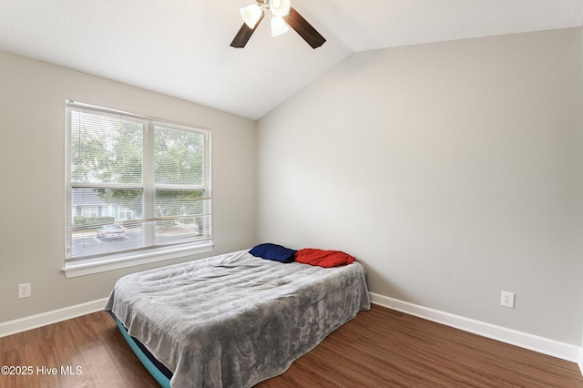 bedroom with lofted ceiling, dark wood-type flooring, and ceiling fan