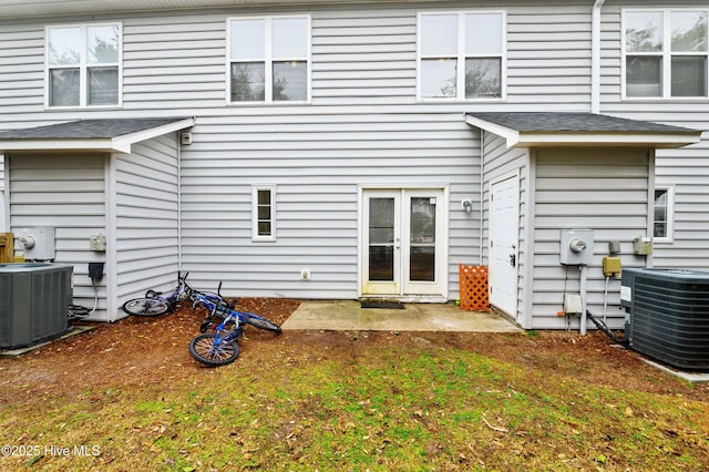 rear view of property with central AC and french doors