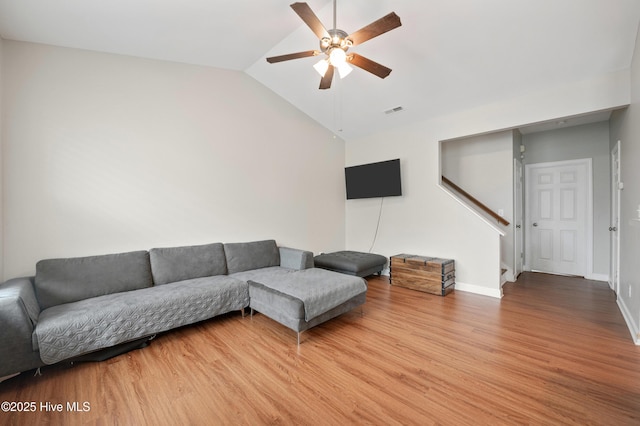 living room with hardwood / wood-style floors, vaulted ceiling, and ceiling fan