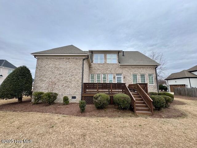 rear view of property with a yard and a deck