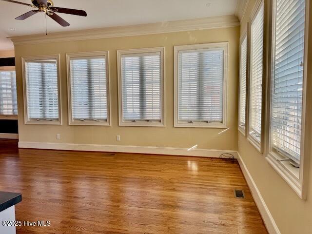 unfurnished living room featuring crown molding, dark hardwood / wood-style floors, and built in features