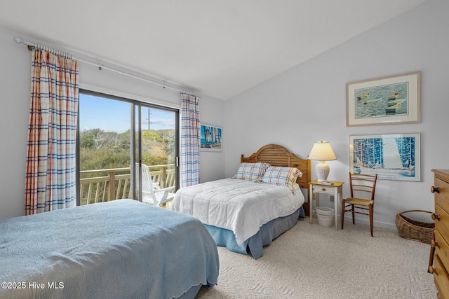 carpeted bedroom with lofted ceiling and access to outside