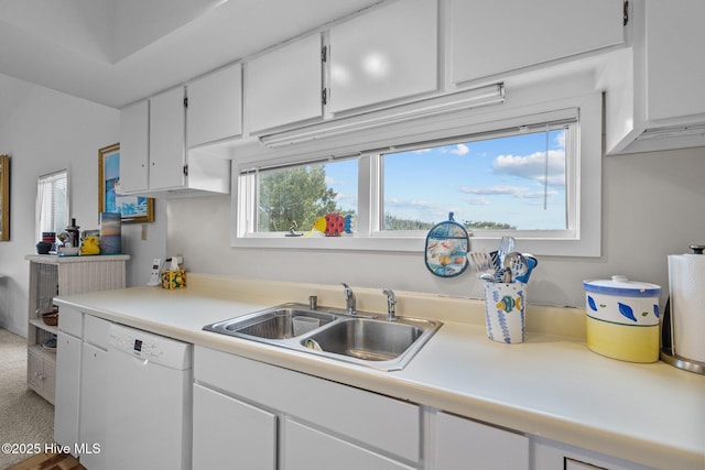 kitchen featuring white cabinetry, white dishwasher, and sink