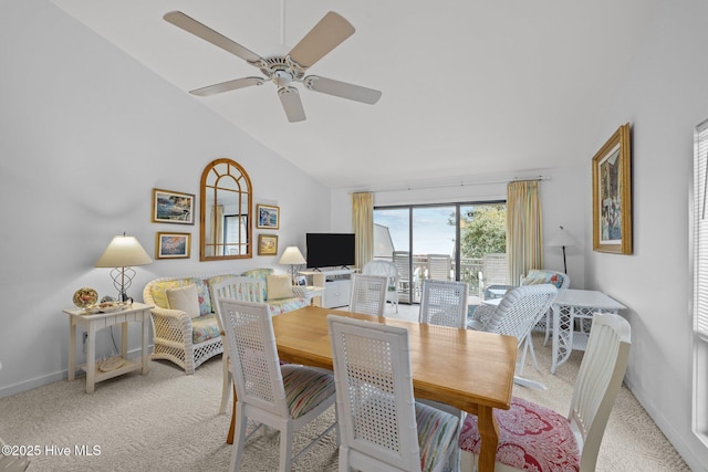 dining room featuring lofted ceiling, light carpet, and ceiling fan