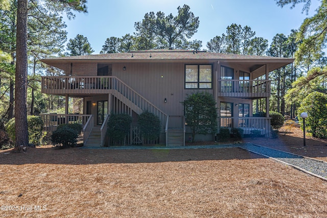 back of house featuring a balcony