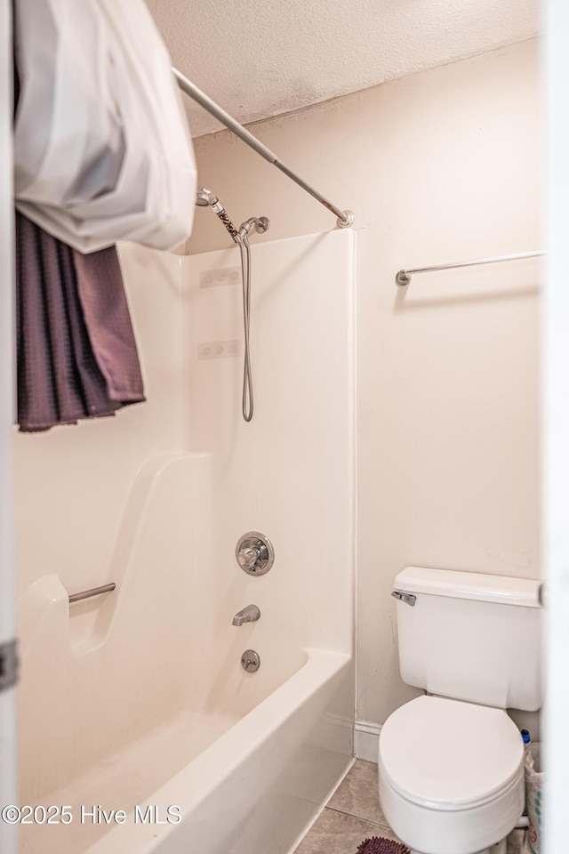 bathroom featuring tile patterned flooring, a textured ceiling, shower / bathtub combination, and toilet