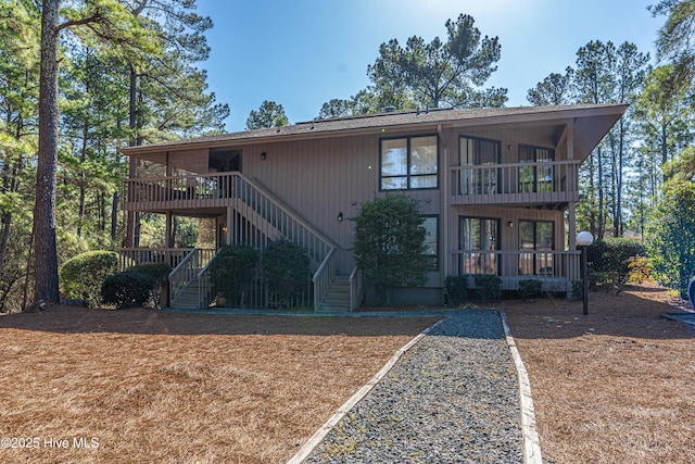 back of property with a balcony