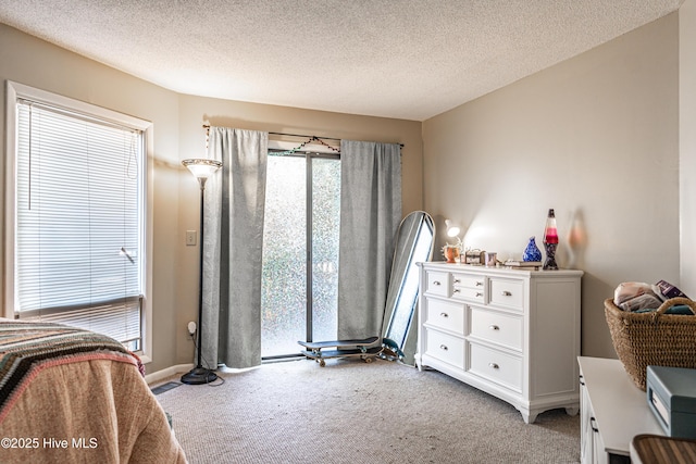 bedroom with light carpet and a textured ceiling