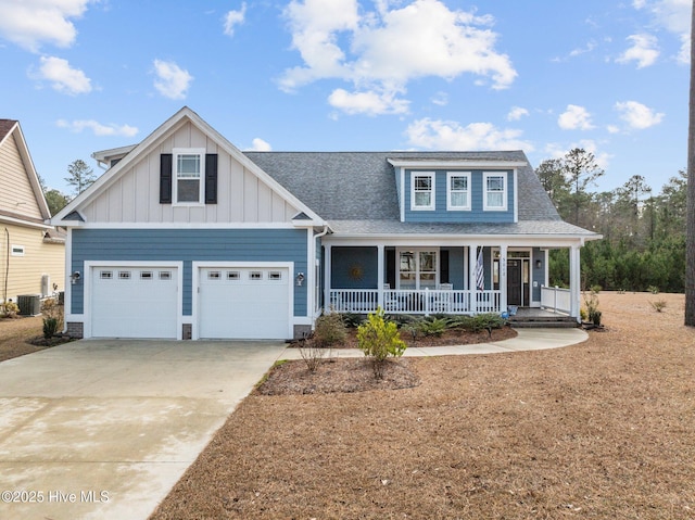 view of front of property featuring a garage, covered porch, and central air condition unit