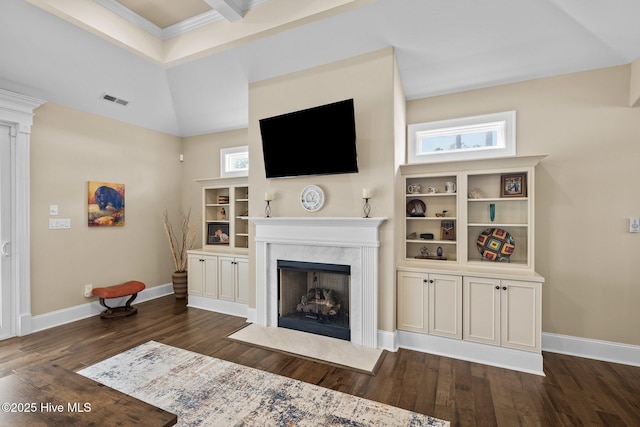 living room with built in shelves, a high end fireplace, dark hardwood / wood-style floors, and vaulted ceiling