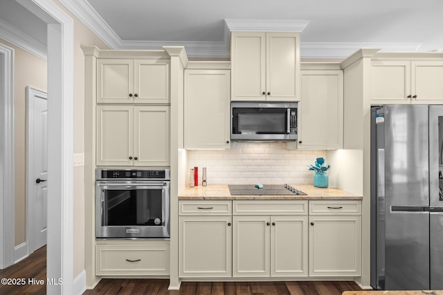 kitchen featuring stainless steel appliances and cream cabinetry