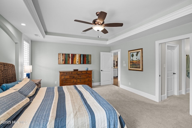 carpeted bedroom featuring a raised ceiling and ceiling fan