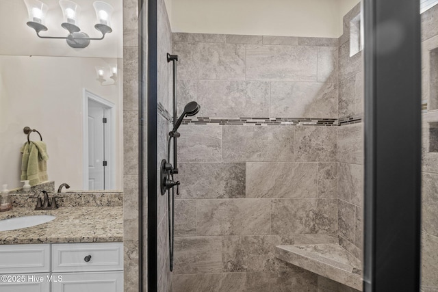 bathroom with vanity and tiled shower