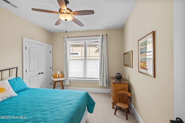 carpeted bedroom with ceiling fan and a closet