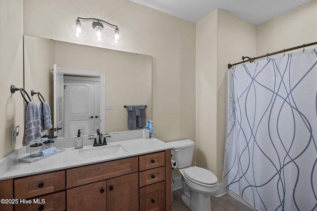 bathroom with vanity, tile patterned flooring, toilet, and walk in shower