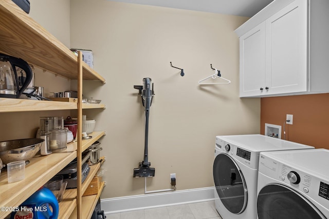 laundry room with cabinets, independent washer and dryer, and light tile patterned floors