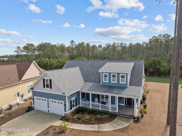 view of front of house featuring a garage, central AC, and a porch