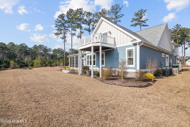 view of side of home featuring cooling unit and a balcony