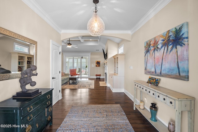 entrance foyer featuring ceiling fan, ornamental molding, and dark hardwood / wood-style flooring