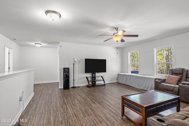 living room with ceiling fan and dark hardwood / wood-style flooring