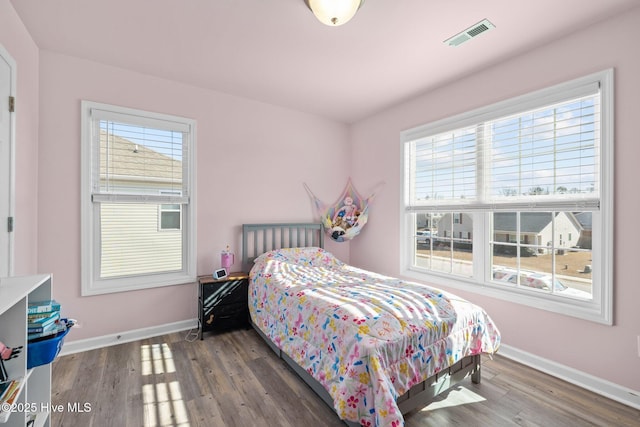 bedroom with dark wood-type flooring