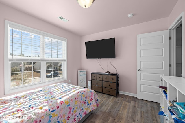 bedroom with dark hardwood / wood-style flooring